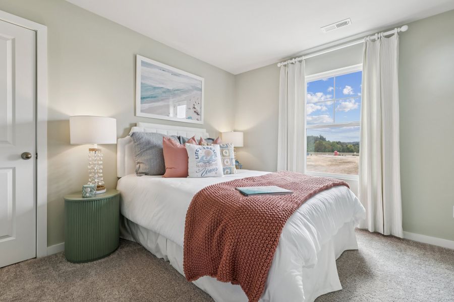 A bedroom with a large window. A bedroom with a large window.