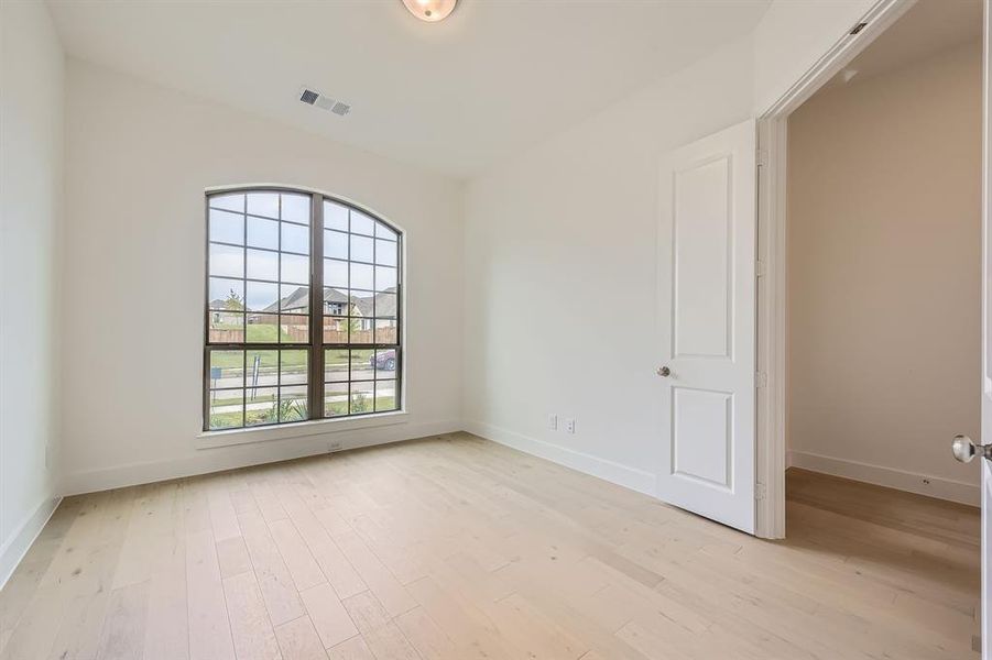 Unfurnished room with light wood-type flooring and baseboards