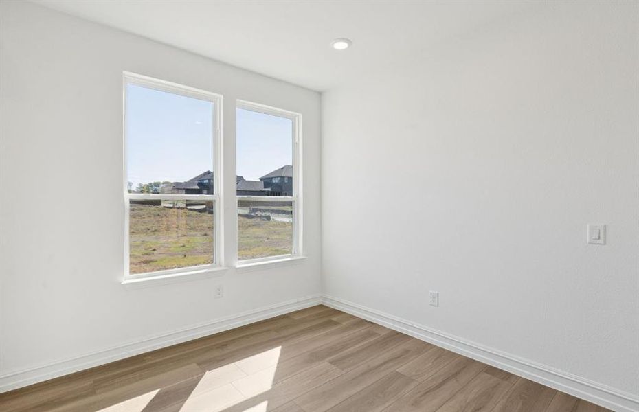 Dining nook off kitchen with large windows