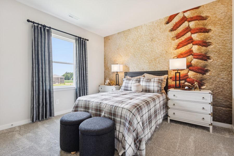A bedroom with a bed and a window. A bedroom with a bed and a window.