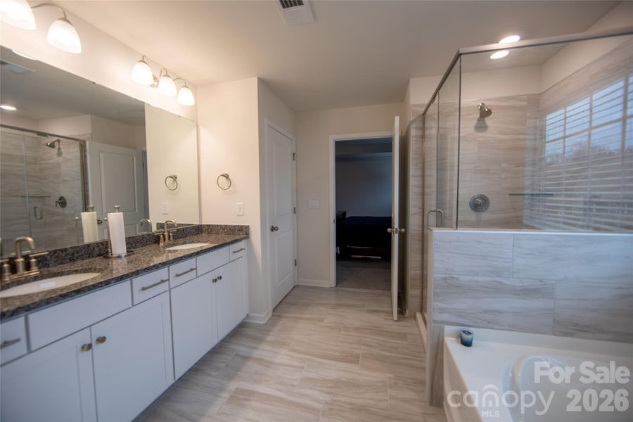 En-suite primary bathroom offering comfort and privacy.