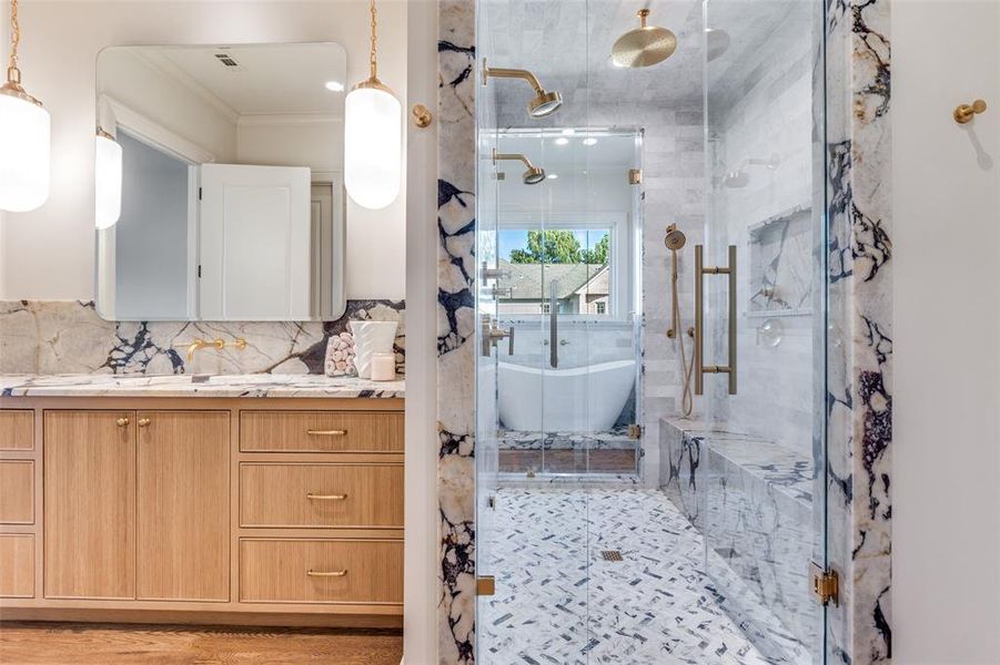 Bathroom with vanity, a freestanding bath, a shower stall, ornamental molding, and backsplash Bathroom with vanity, a freestanding bath, a shower stall, ornamental molding, and backsplash