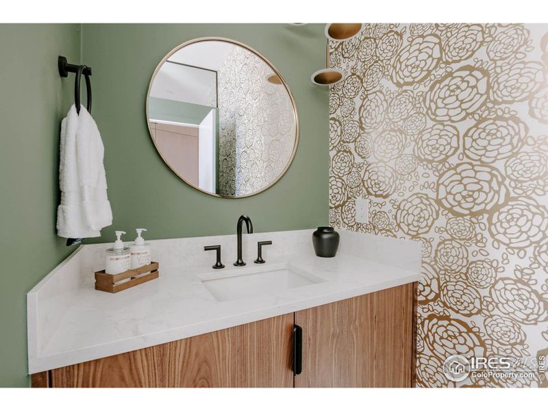 Powder room with floating vanity and peek-a boo wallpaper