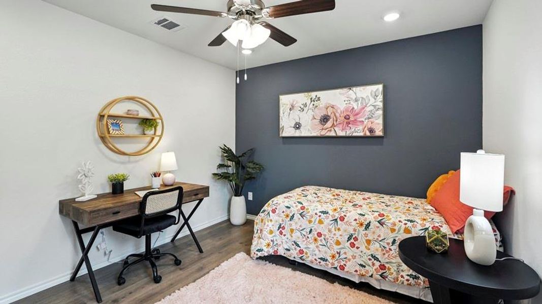 Bedroom with wood finished floors, ceiling fan, an accent wall, recessed lighting, and a desk Bedroom with wood finished floors, ceiling fan, an accent wall, recessed lighting, and a desk