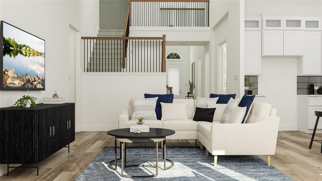 Living room featuring a high ceiling and light hardwood / wood-style floors