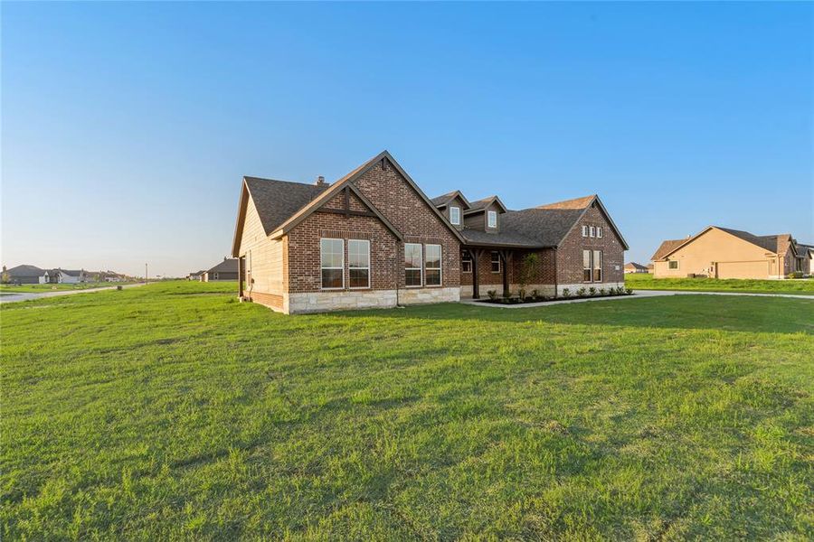 Front exterior of a new home in Oak Valley, Oak Ridge, TX, highlighting curb appeal (Image 1).