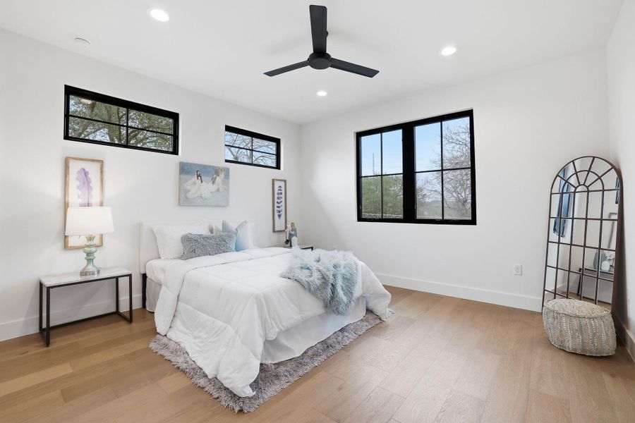 Bedroom featuring light wood-type flooring, a ceiling fan, and recessed lighting