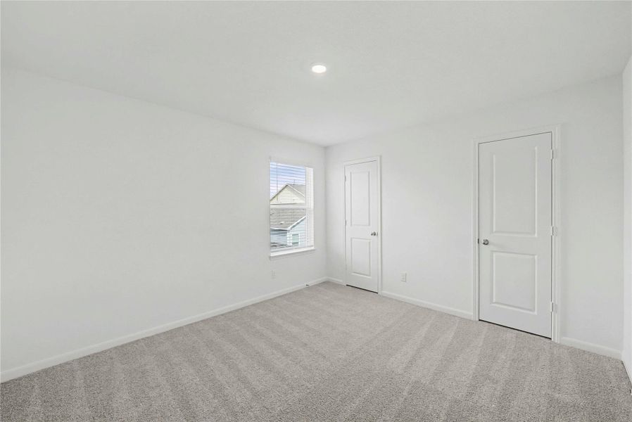 Unfurnished bedroom with carpet floors and baseboards