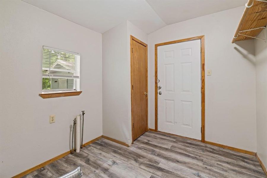 Laundry area featuring light wood-style flooring and baseboards Laundry area featuring light wood-style flooring and baseboards