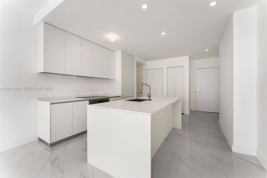 Modern chef’s kitchen equipped with custom Italian cabinetry, premium Miele appliances, integrated stone countertops, and a waterfall island perfect for entertaining.