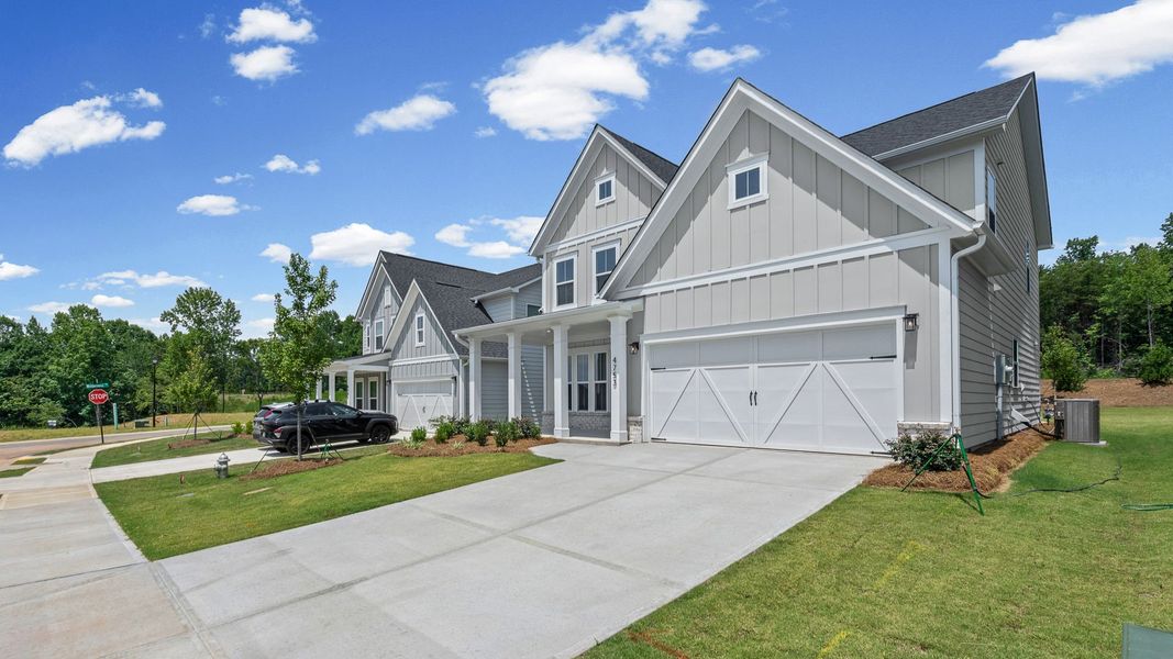 Front exterior of a new home in Hunters Creek, Flowery Branch, GA, highlighting curb appeal (Image 1). Front exterior of a new home in Hunters Creek, Flowery Branch, GA, highlighting curb appeal (Image 1).