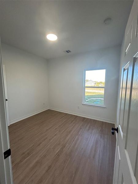 Empty room with dark hardwood / wood-style floors