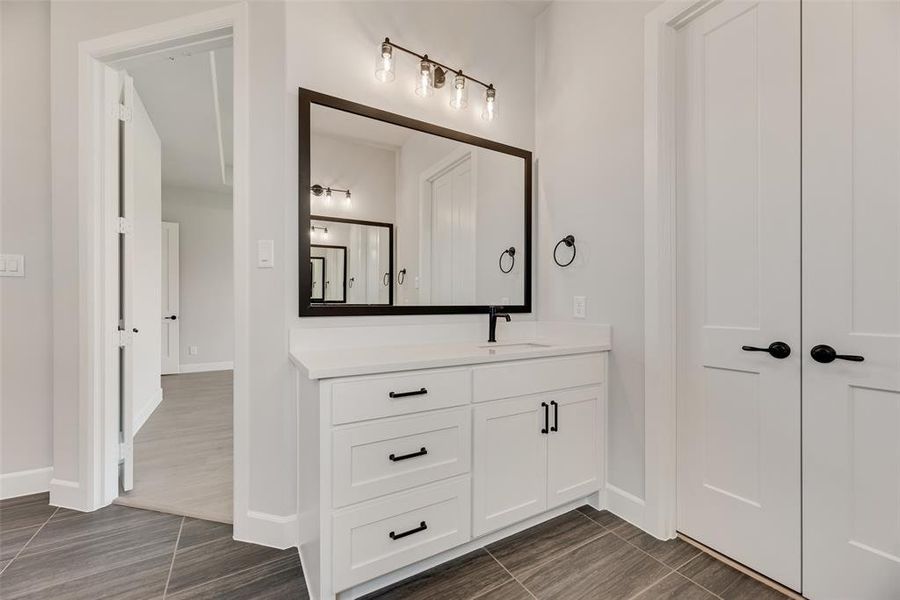 Bathroom featuring vanity and wood finish floors