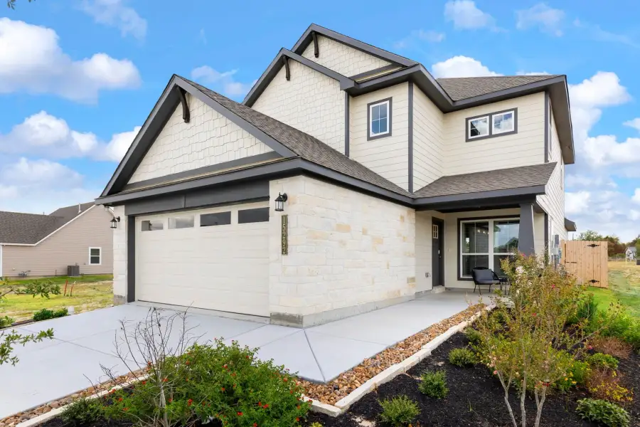 Front exterior of a new home in Heartland at Creek Meadows, College Station, TX, highlighting curb appeal (Image 2). Front exterior of a new home in Heartland at Creek Meadows, College Station, TX, highlighting curb appeal (Image 2).