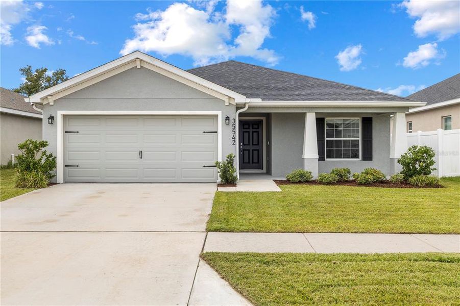 Front exterior of a new home in Stonebridge North, Zephyrhills, FL, highlighting curb appeal (Image 23). Front exterior of a new home in Stonebridge North, Zephyrhills, FL, highlighting curb appeal (Image 23).