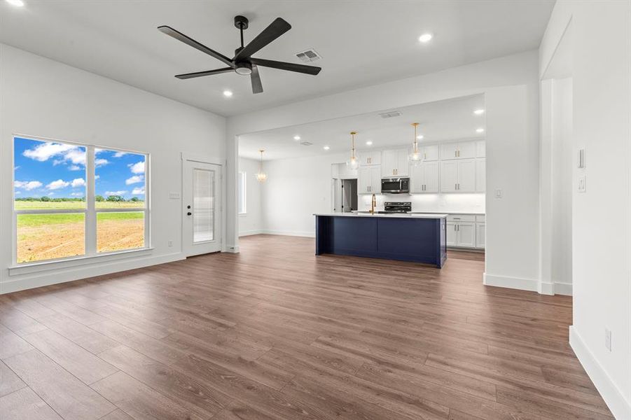 Unfurnished living room with dark wood-style flooring, recessed lighting, and a ceiling fan