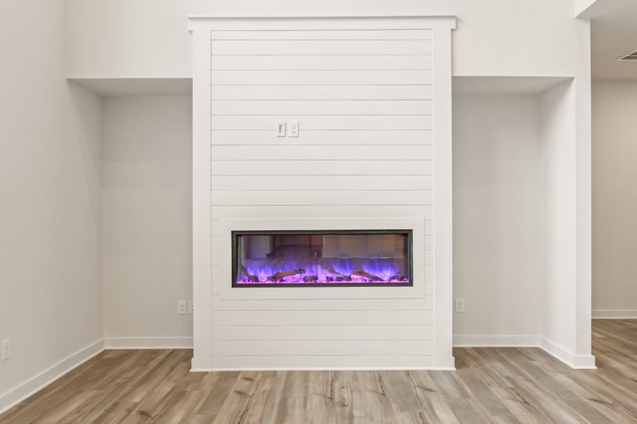 A fireplace in a room. A fireplace in a room.