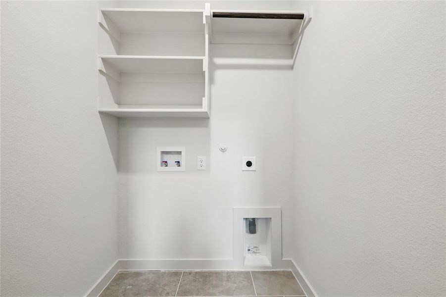 Laundry area with gas dryer hookup, hookup for a washing machine, hookup for an electric dryer, and a textured wall