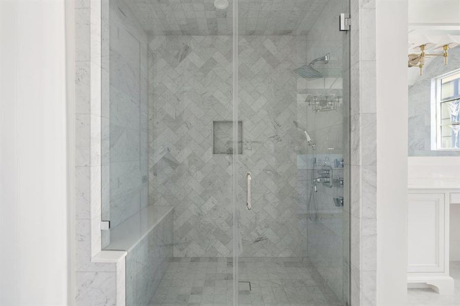 The spa-inspired retreat is complete with a frameless marble shower with over head rain shower, handheld sprayer, body spray jets and bench seating. (photo of interior model home with smaller floor plan)