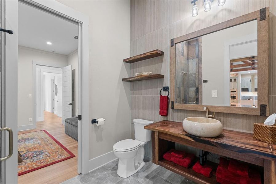Full bathroom featuring vanity, crown molding, and light tile patterned flooring