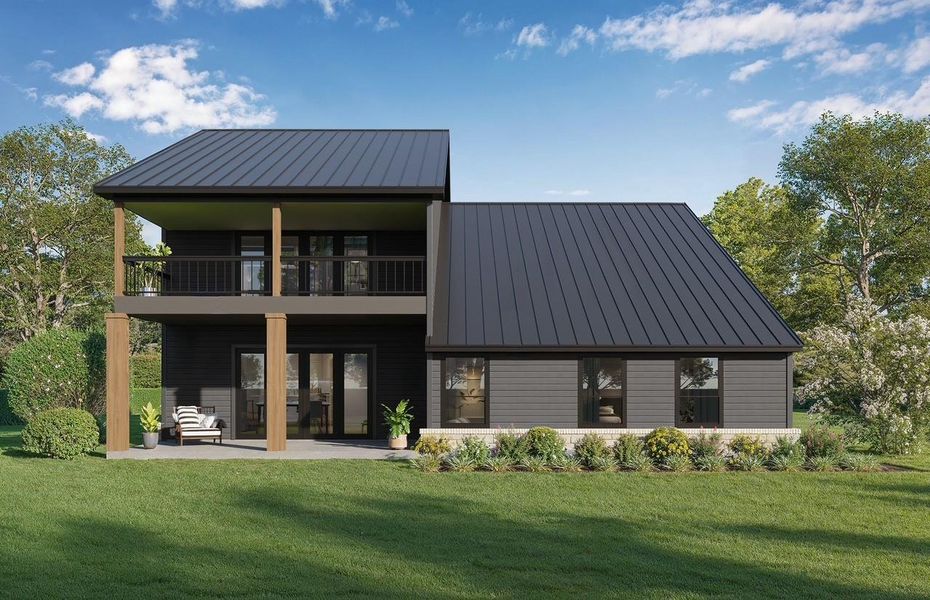 Back of property featuring a standing seam roof, a patio, a lawn, and a balcony