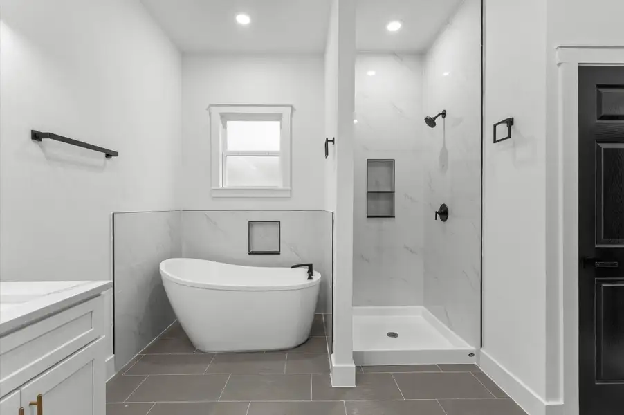 Luxurious spa-style bathroom with dual vanities, free standing bathtub and shower. Luxurious spa-style bathroom with dual vanities, free standing bathtub and shower.