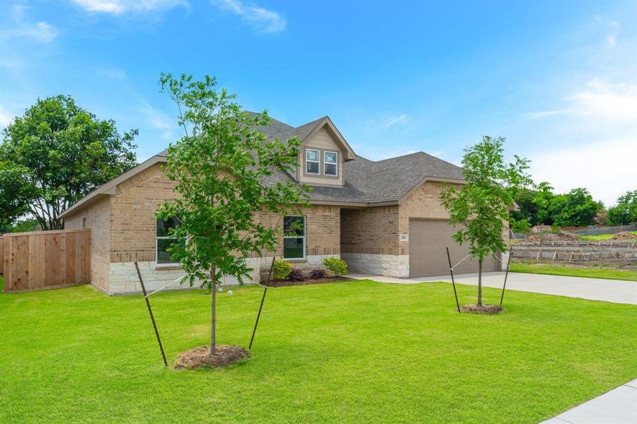 Craftsman inspired home with a garage and a front lawn