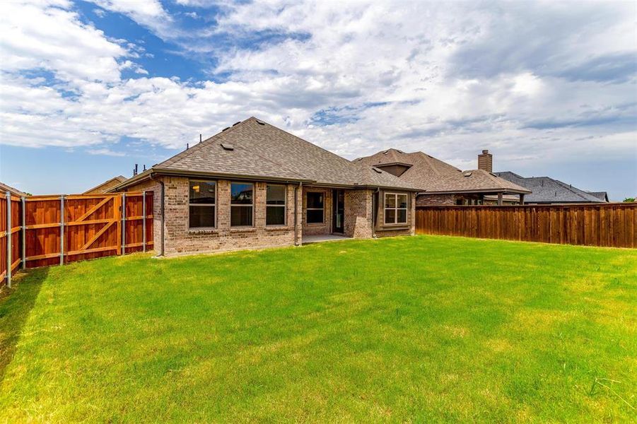 Rear view of property featuring a lawn