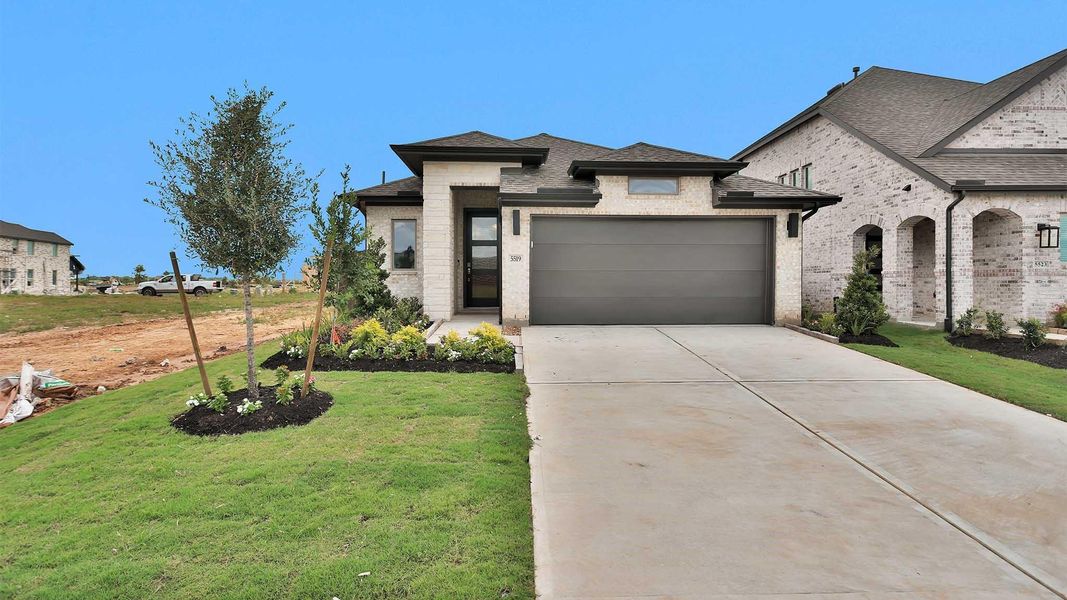 Front exterior of a new home in Brookewater, Rosenberg, TX, highlighting curb appeal (Image 1). Front exterior of a new home in Brookewater, Rosenberg, TX, highlighting curb appeal (Image 1).