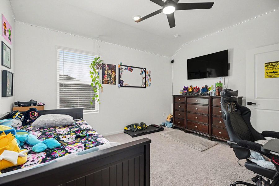 Secondary bedroom with plush carpeting, a large window, and a comfortable layout. Secondary bedroom with plush carpeting, a large window, and a comfortable layout.