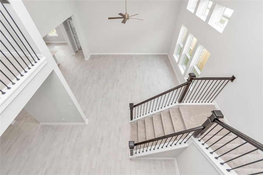 View from second floor. Bright and open floor plan. Sample photo of completed home with similar floor plan. As-built interior colors and selections may vary