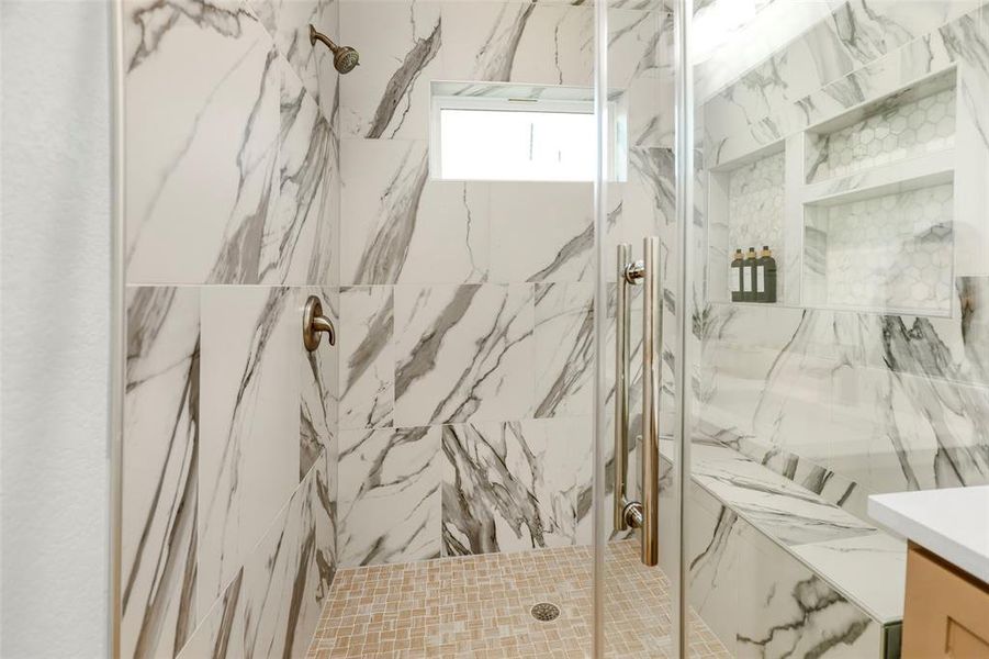 Luxurious primary bathroom with private toilet room and walk-in closet