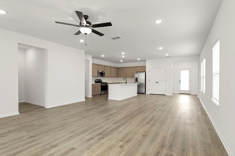 Unfurnished living room with recessed lighting, ceiling fan, and light wood finished floors