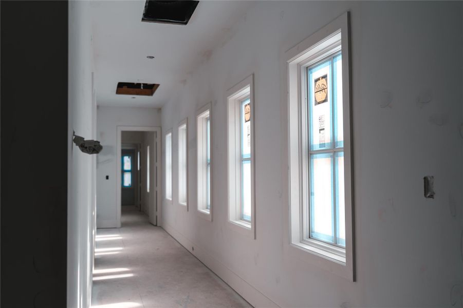 Upstairs corridor to primary suite enjoys great natural light