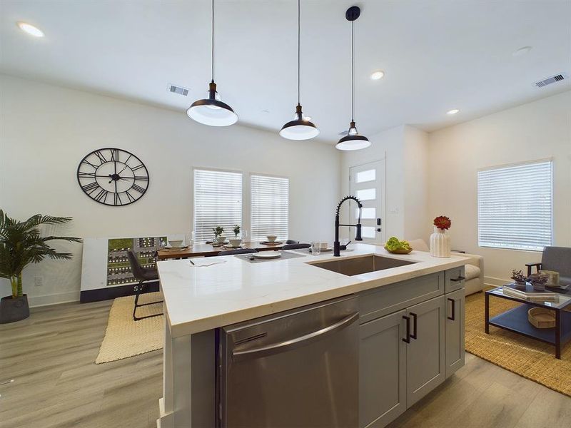 This attractive kitchen is full of beautiful details. Quartz countertops, stainless steel sink, stainless steel appliances, recessed lighting, undercabinet lighting, pantry, elegant cabinetry with soft close drawers and doors. Photos from another development by Disama Building Group. FINISHES & COLORS MAY VARY.