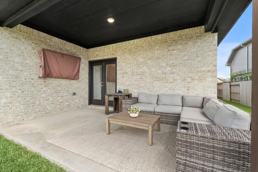The covered patio is perfect for your outdoor living space, patio furniture, or BBQ pit! The french doors connect to the main living area making it great for indoor/outdoor living and entertaining. *This photo has been virtually staged