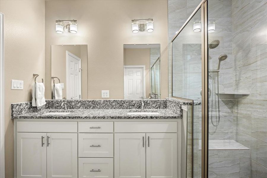 Full bathroom with a shower stall and double vanity Full bathroom with a shower stall and double vanity