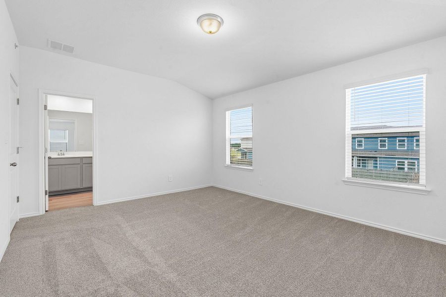 Carpeted room with white walls, two windows, and a flush mount ceiling light Carpeted room with white walls, two windows, and a flush mount ceiling light