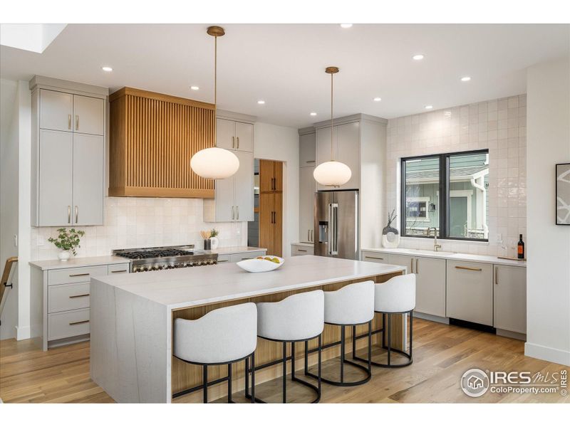 This beautiful double waterfall quartz island comfortably seats four for in-kitchen dining