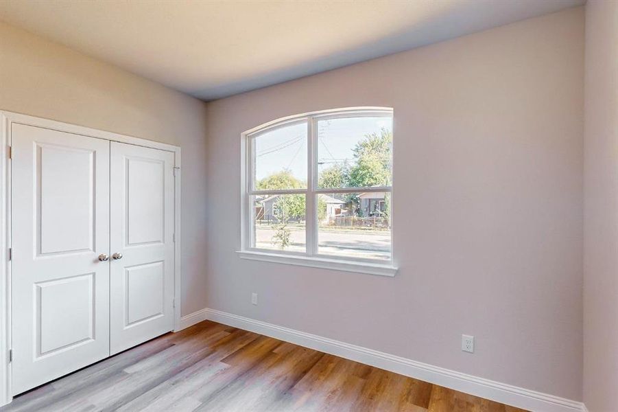 Unfurnished bedroom with a closet and light hardwood / wood-style floors