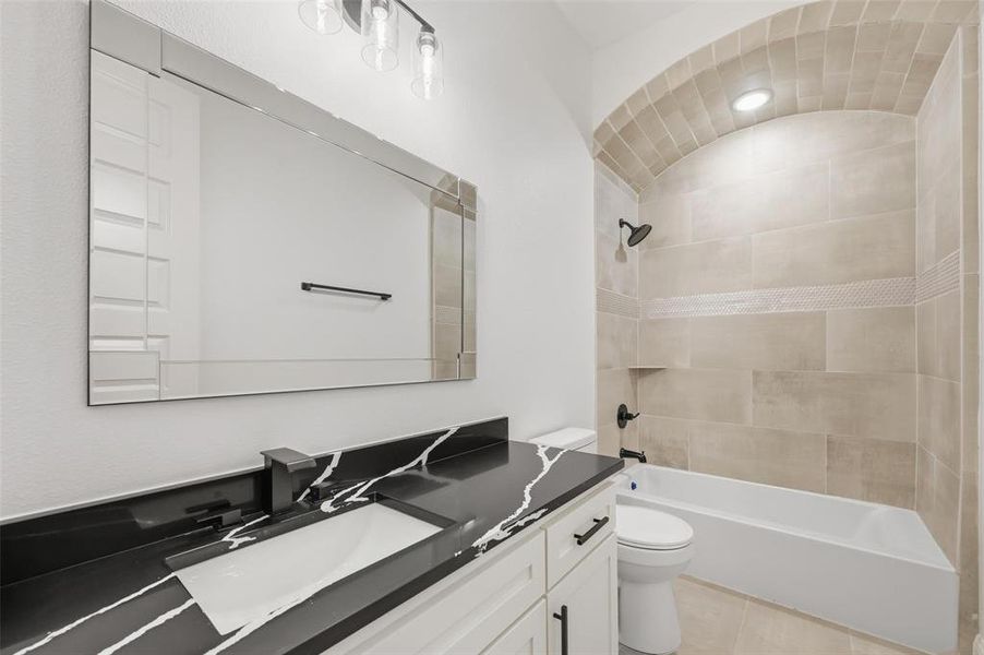 Full bath with vanity, tub / shower combination, and light tile patterned floors