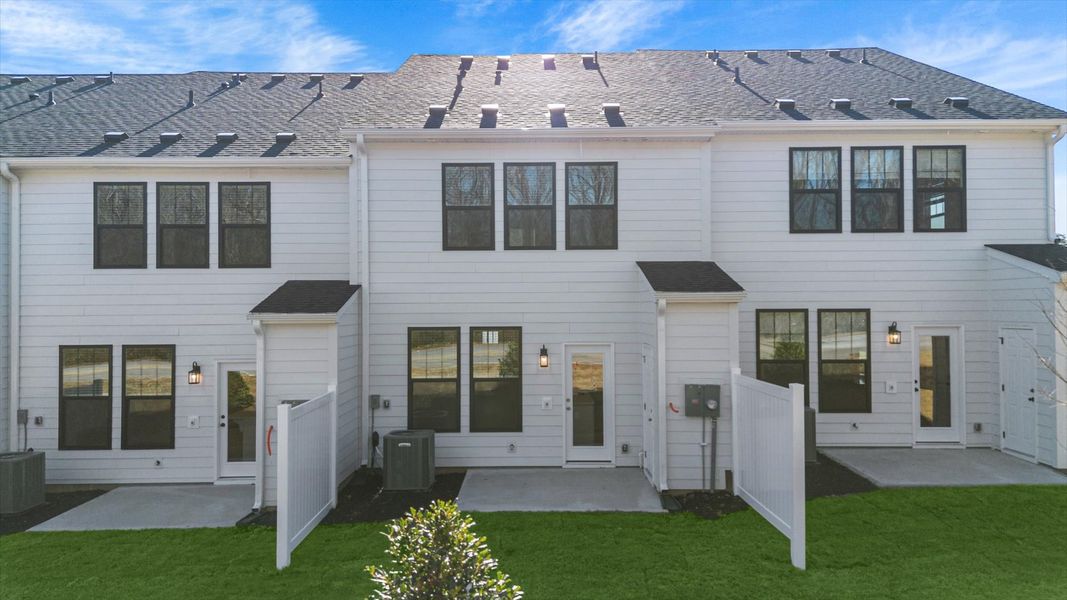 Backyard creates a seamless extension of this townhome’s elegant design at Gresham Station in Simpsonville, SC