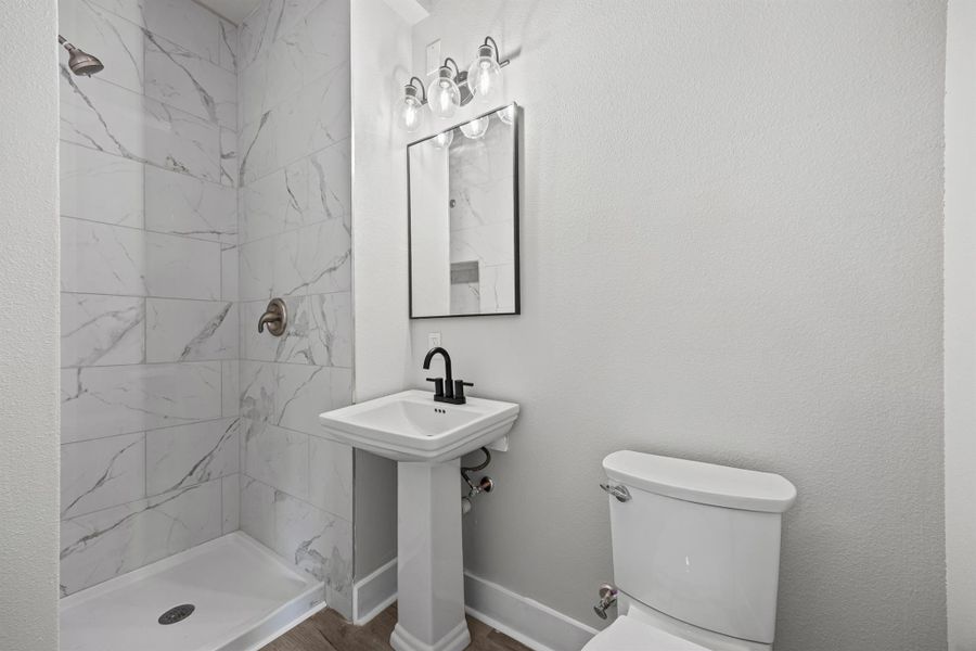 Bathroom with a stall shower and toilet Bathroom with a stall shower and toilet