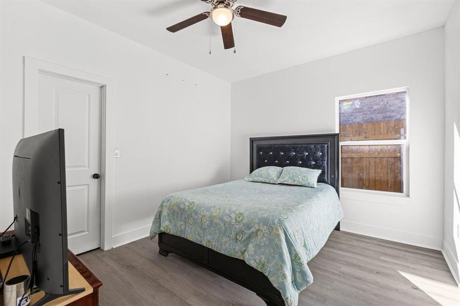 Bedroom with ceiling fan and hardwood / wood-style flooring