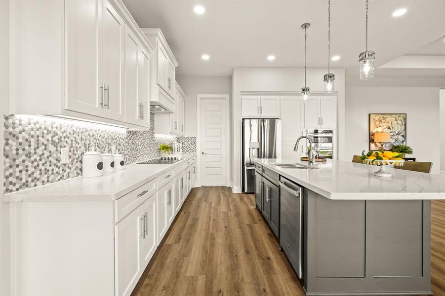 This Kitchen is both chic and timeless. The fresh, white, shaker-styled cabinets and quartz countertops are tastefully accented by a moody, slate-colored island. The tile backsplash then marries the two perfectly by tying both colors together in a chic, metaphorical bow.