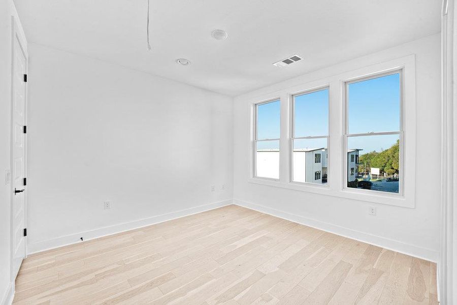 Empty room featuring light wood-style floors and baseboards