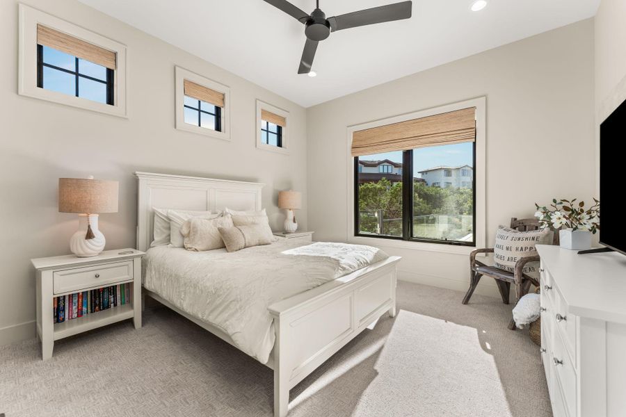 Bedroom with light carpet, ceiling fan, and recessed lighting Bedroom with light carpet, ceiling fan, and recessed lighting