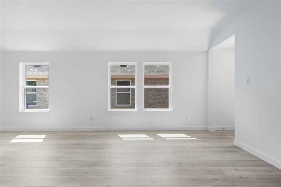Spare room featuring plenty of natural light and light wood-style flooring Spare room featuring plenty of natural light and light wood-style flooring