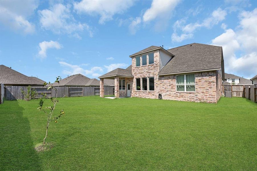 The property features gates on both side of the home and 4 fruit bearing trees.