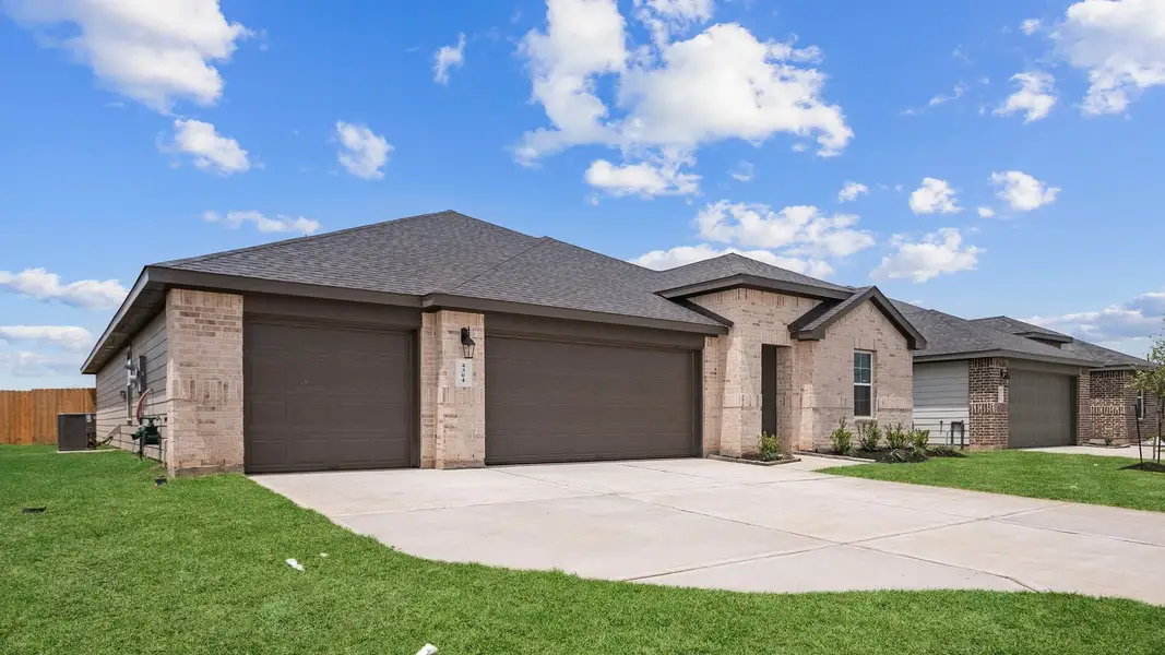 Front exterior of a new home in Tamarron, Fulshear, TX, highlighting curb appeal (Image 21).